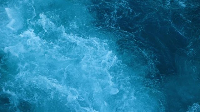 Blue sea water with boat trace. Slow motion.