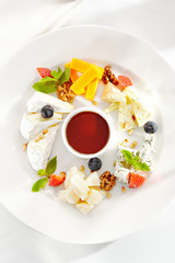 Gourmet, restaurant, delicious dinner food - close up of cheese plate with honey dip and fresh berries