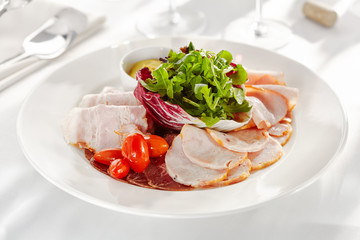 Gourmet, restaurant, delicious dinner food - close up of Sliced Meats with Rocket Salad and Tomatoes