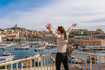 Tourist woman in French historical city Marseille and Mediterranean sea coast. Marseille is the...