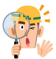 虫眼鏡を覗いて驚く工事現場、ヘルメットを被った男性