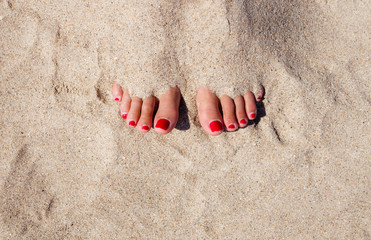 Beach portrait of beautiful sexy tanned slim woman relaxing in summer sunny hot day. Close up legs with clear sand. Lifestyle luxury tropical vacation concept.