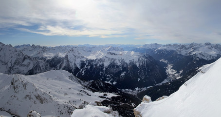 Panoramic view of Val di Fassa with Canazei and Campitello villages from Sas Pordoi in winter. Dolomite Alps (Sella Ronda). Italy.
