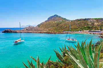 Sea skyview landscape photo Ladiko bay near Anthony Quinn bay on Rhodes island, Dodecanese, Greece. Panorama with nice sand beach and clear blue water. Famous tourist destination in South Europe - obrazy, fototapety, plakaty