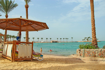 People enjoy holidays in Egyptian resort on sandy beach