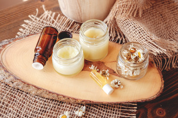 Hand cream and lip balm in a glass jar. Natural organic cosmetics with honey, wax and oils.