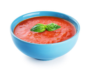 Bowl of tomato soup isolated on a white background.