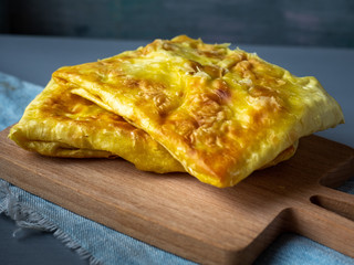 Hot baked sandwiches with meat and vegetables, serving on a wooden stick