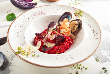 Red beetroot risotto with chrimps, prowns, mussels and parmesan cheese
