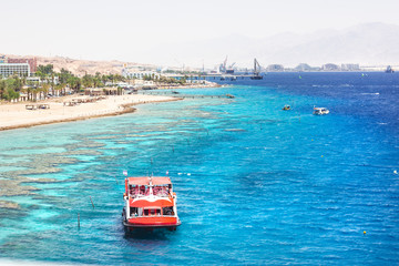EILAT, ISRAEL - JUNE 14, 2014: Redboat with tourists at sea in the bay of Eilat, Israel. 