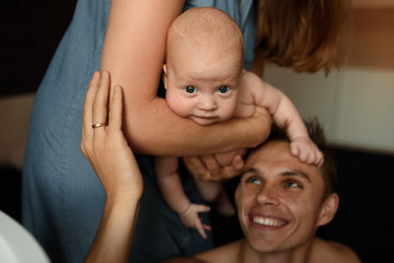 Young parents have fun with their little son