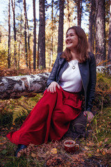 Portrait of a beautiful happy woman with a smile in autumn yellow leaf forest or park, seasonal enjoy time, september weather