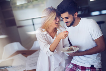 Cute young cheerful couple spending time at home