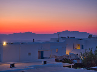 Breathtaking sunset at exotic city with white plain buildings