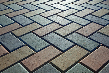 Background - colorful cobblestone pavement of the new paving stones. Diminishing perspective....
