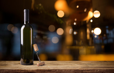 Expensive wine bottles collection and wooden barrel in the cellar, wine tasting and production...