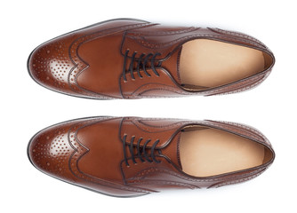 Classic male leather shoes isolated on a white, top view.
