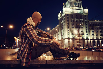 Fototapeta na wymiar man night city lights, urban lonely guy concept, stress, road, car city lights in the background