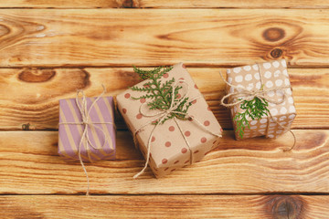 Small christmas gifts on wooden background, view from above