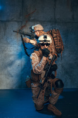 Two well equipped US army commandos armed with assault rifles. Studio shot