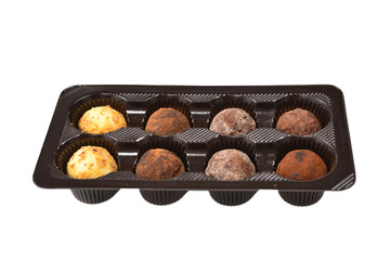 Chocolate candy collection in plastic box.