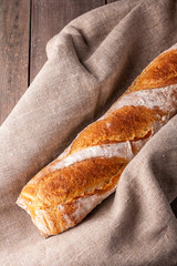 Hot french bagette on roustic wrap in boulangerie. Bred, food, closeup