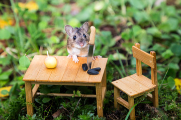 In the forest, a small mouse sits at a small table on which lies an apple and seeds and a knife,...
