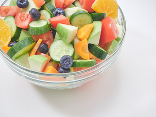 Mixed fruit and vegetable salad in a glass bowl