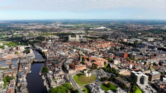 Aerial footage of the town of York located in North East England and founded by the ancient Romans, the footage shows the main town centre along the river.
