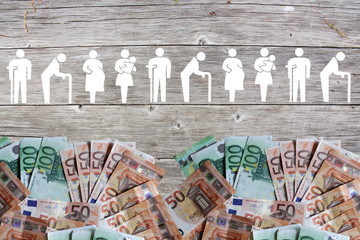 Weak social categories welfare concept with euro banknotes on wooden background