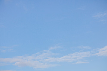 Naklejka na ściany i meble Pastel blue sky with soft clouds.