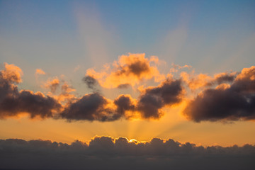 Sun setting over a golden blue sunset over the ocean.