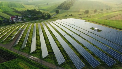 Aerial view to solar power plant. Industrial background on renewable resources theme. - Powered by Adobe