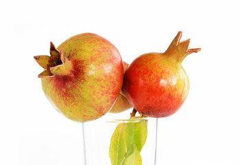 fruits of a natural unripe green orange pomegranate on a white background