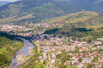 Naklejka premium Ukraine Carpathians, a settlement in a valley of mountains, beautiful landscape aerial view