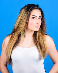 Hairdresser salon. Damaged hair. Voluminous crimped hair. Styling cosmetic product. Crimped hairstyles. Woman stylish hairstyle on blue background. Hair crimping method styling hair becomes wavy