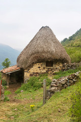 Plakat La Pornacal hiking route in Somiedo natural park, Spain, with straw roof houses