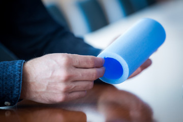 Hand holding a roll of foam