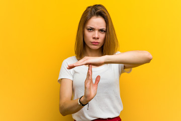 Young natural caucasian woman showing a timeout gesture.