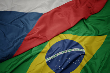 waving colorful flag of brazil and national flag of czech republic.