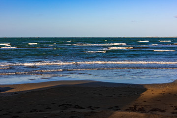 Shadows fall on an empty warm beach