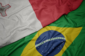waving colorful flag of brazil and national flag of malta.