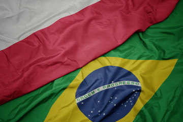 waving colorful flag of brazil and national flag of poland.