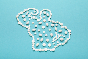 Silhouette of muscular bodybuilder made of pills of sport meal and supplements. BCAA amino acids, L - Carnitine capsules.