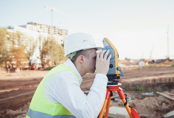 surveyor man in white helmet on construction site
