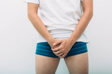 man wearing underpants holding genitals prostate problem. Men's health, venereologist, sexual...