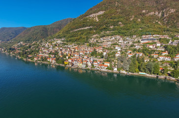 Aerial view landscape on beatiful Lake Como in Carate Urio, Lombardy, Italy. Scenic small town with traditional houses and clear blue water. Summer tourist vacation on rich resort with nice harbour
