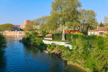 Fototapeta na wymiar French ancient town Toulouse and Garonne river panoramic view. Toulouse is the capital of Haute Garonne department and Occitanie region, France, South Europe. Famous city and tourist destionation.