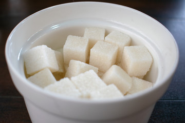 Fototapeta na wymiar Refined sugar cubes in a sugar bowl.
