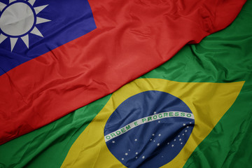 waving colorful flag of brazil and national flag of taiwan.